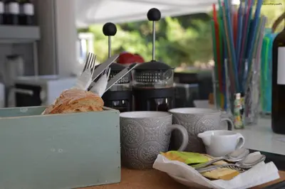 a table with a box with a sandwich and cups at Kiwi Apartments in Kato Daratso