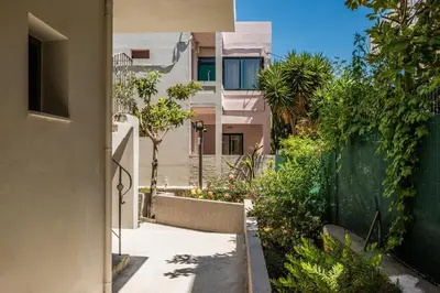 an alley with a house and a fence at Kiwi Apartments in Kato Daratso