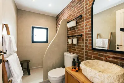 a bathroom with a large sink and a brick wall at San Pietro Villa in Plataniás