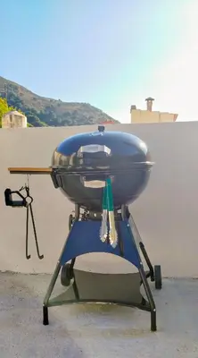 a blue grill sitting on top of a chair at Feneri Traditional House Apt 1- 20' from Elafonisi beach in Elafonisi
