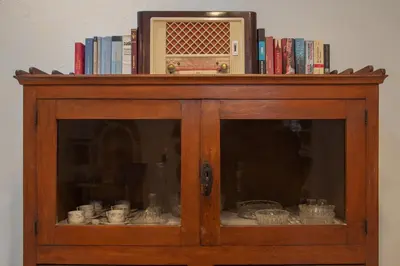 a wooden cabinet with books on top of it at Feneri Traditional House Apt 1- 20' from Elafonisi beach in Elafonisi