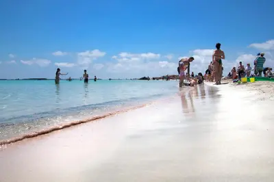 a group of people on a beach in the water at Feneri Traditional House Apt 1- 20' from Elafonisi beach in Elafonisi