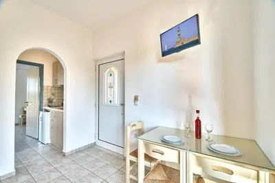 a kitchen with a table and a dining room at Solon Apartments in Maleme