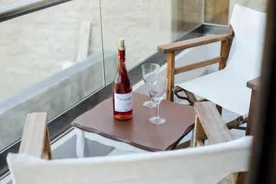 a bottle of wine sitting on a table with two glasses at Trigono Luxury House in Kissamos