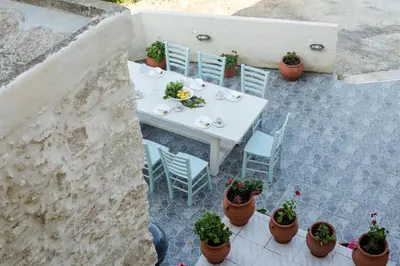 an overhead view of a white table and chairs and plants at Trigono Luxury House in Kissamos