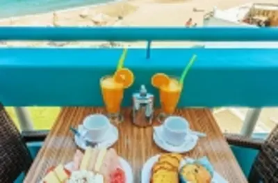 a table with plates of food and drinks on it at Hotel Christina in Chania Town