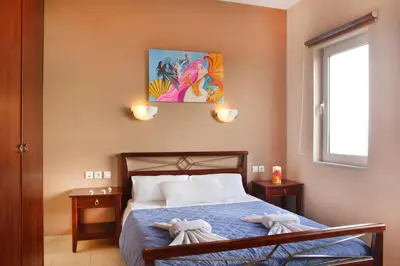 a bedroom with a bed with two towels on it at Nikos Apartments in Falasarna
