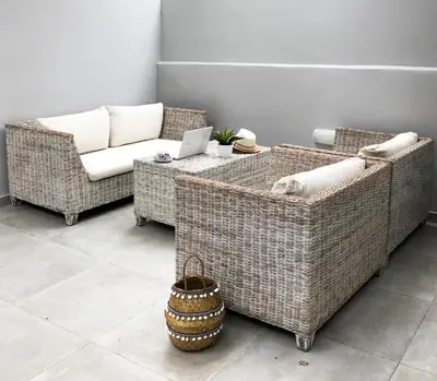 two wicker chairs and a table with a laptop on it at Stelisia Rooms in Chania Town