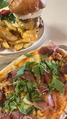 two plates of food with a hamburger and fries at Stelisia Rooms in Chania Town
