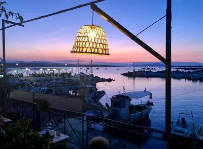 a chandelier hanging over a marina at sunset at Stelisia Rooms in Chania Town