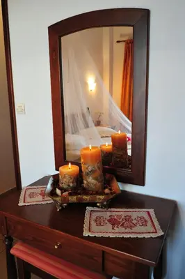 a table with candles on it with a mirror at Kavousi Resort in Falasarna