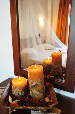 a group of candles on a tray in front of a mirror at Kavousi Resort in Falasarna