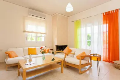 a living room with a couch and a table at Rodanthi Villas in Darmarochori