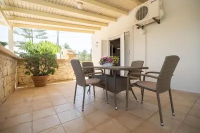 a dining room with a table and chairs at Rodanthi Villas in Darmarochori