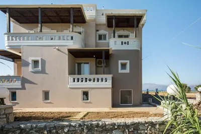 a large house with balconies on the side of it at Vasso Apartments in Kissamos