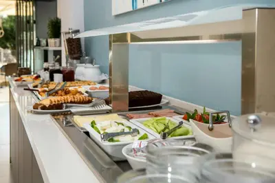 a buffet line with many different types of food at Aphrodite Beach in Kissamos