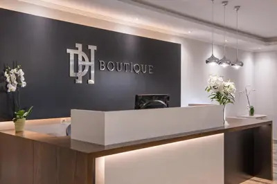 a boutique lobby with a reception desk and flowers at Dore Boutique Hotel in Agia Marina Nea Kydonias