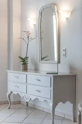 a dresser with a mirror on top of it at Dore Boutique Hotel in Agia Marina Nea Kydonias