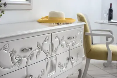 a yellow chair with a hat on top of a dresser at Dore Boutique Hotel in Agia Marina Nea Kydonias