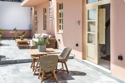 a patio with a wooden table and chairs at Avra Apartments Kolymbari Harbour in Kolymvari