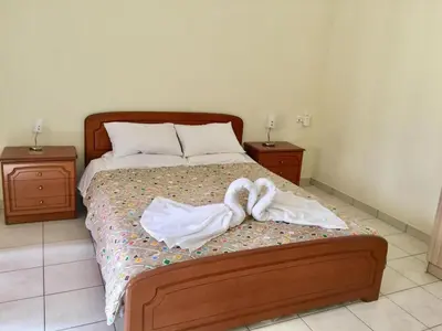 a bedroom with a bed with two towels on it at Irene's studio in chania in Chania Town