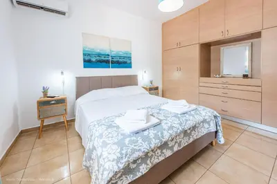 a bedroom with a bed with two towels on it at Orama in Kato Daratso