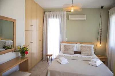 a bedroom with a bed with towels on it at Althea Maisonettes in Áptera