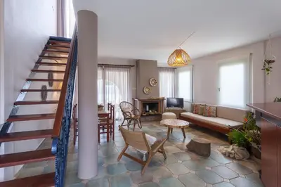 a living room with a staircase and a living room at Althea Maisonettes in Áptera