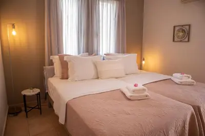 a bedroom with two white towels on a bed at Althea Maisonettes in Áptera