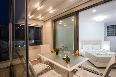 a room with a bed and a table and chairs at Elmaya's Duplex in Kissamos