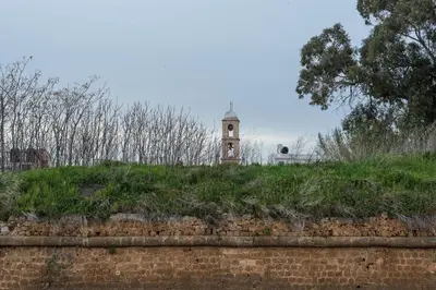 a clock tower sitting on top of a brick wall at Grande Casa 1926 in Chania Town