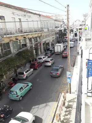 a busy city street filled with lots of cars at Casa 1926 in Chania Town