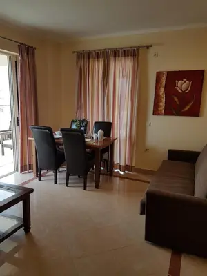 a living room with a table and chairs and a couch at Rastoni Apartments in Kissamos