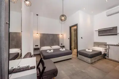 a bedroom with two beds and a couch at Xasteria in Elafonisi