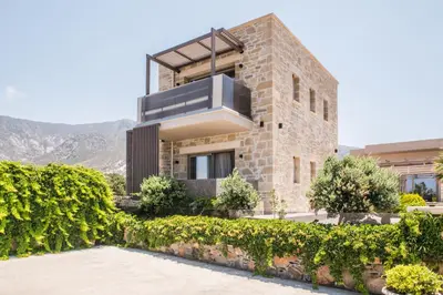 a brick house with a balcony on top of it at Xasteria in Elafonisi