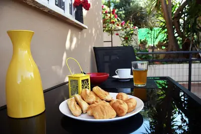 a plate of pastries on a table with a drink at Coco Studio in Chania Town