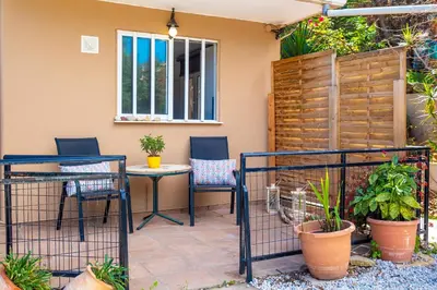 a patio with a table and chairs and plants at Coco Studio in Chania Town