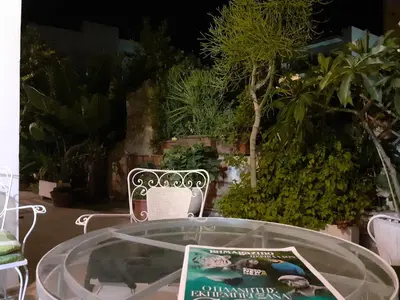 a glass table with a book on top of it at Diana Rooms in Chania Town