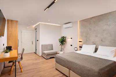 a bedroom with a bed and a desk and a chair at Morfeas Hotel in Chania Town