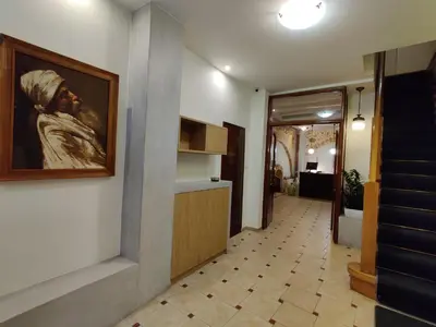a hallway with a painting of a man on the wall at Morfeas Hotel in Chania Town