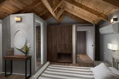 a bedroom with a large bed and a mirror at Morfeas Hotel in Chania Town