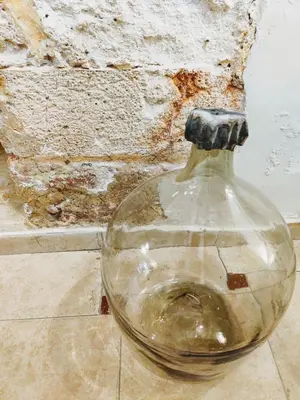 a glass bottle sitting on the floor next to a wall at Morfeas Hotel in Chania Town
