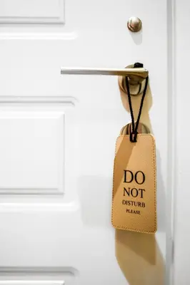 a tag that says do not disturb them hanging on a door at Morfeas Hotel in Chania Town