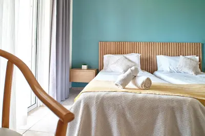 a bedroom with a large bed with white pillows at Pegasus Hotel in Stalos