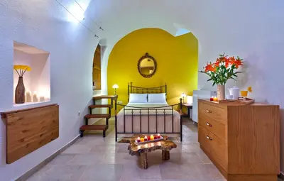 a bedroom with a bed and a table in a room at Kores Boutique Houses in Chania Town