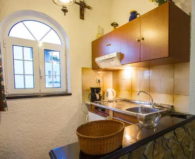 a kitchen with a sink and a window at Konaki Apartments in Maleme