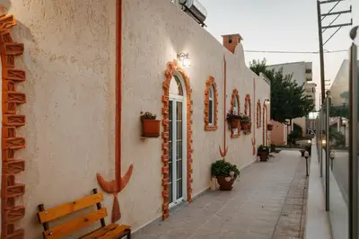 a building with a bench on the side of a street at Konaki Apartments in Maleme