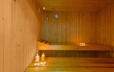 a sauna with two candles and a clock in it at Daphnis Villas in Maleme