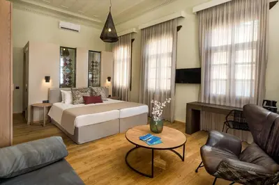 a living room with a bed and a couch and a table at ELG Contessa Boutique Hotel in Chania Town