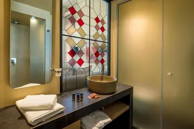 a bathroom with a bowl sink and a mirror at ELG Contessa Boutique Hotel in Chania Town